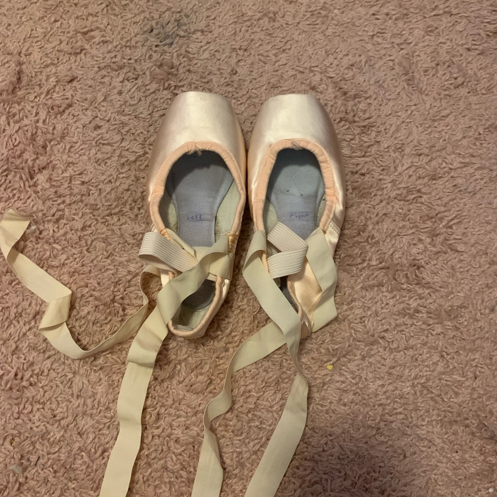 2 pairs of pointe shoes and 1 pair of flat shoes